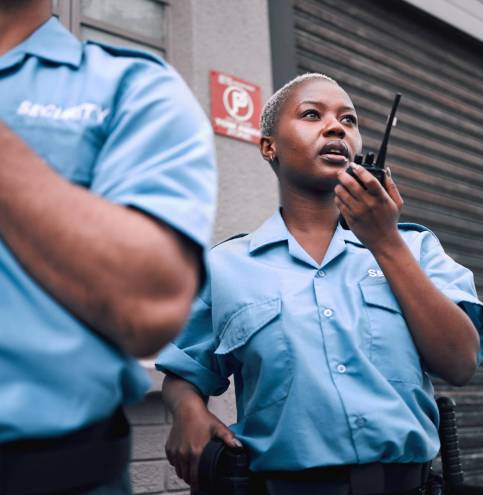 Security, walkie talkie and a black woman police officer in the city during her patrol for safety o.